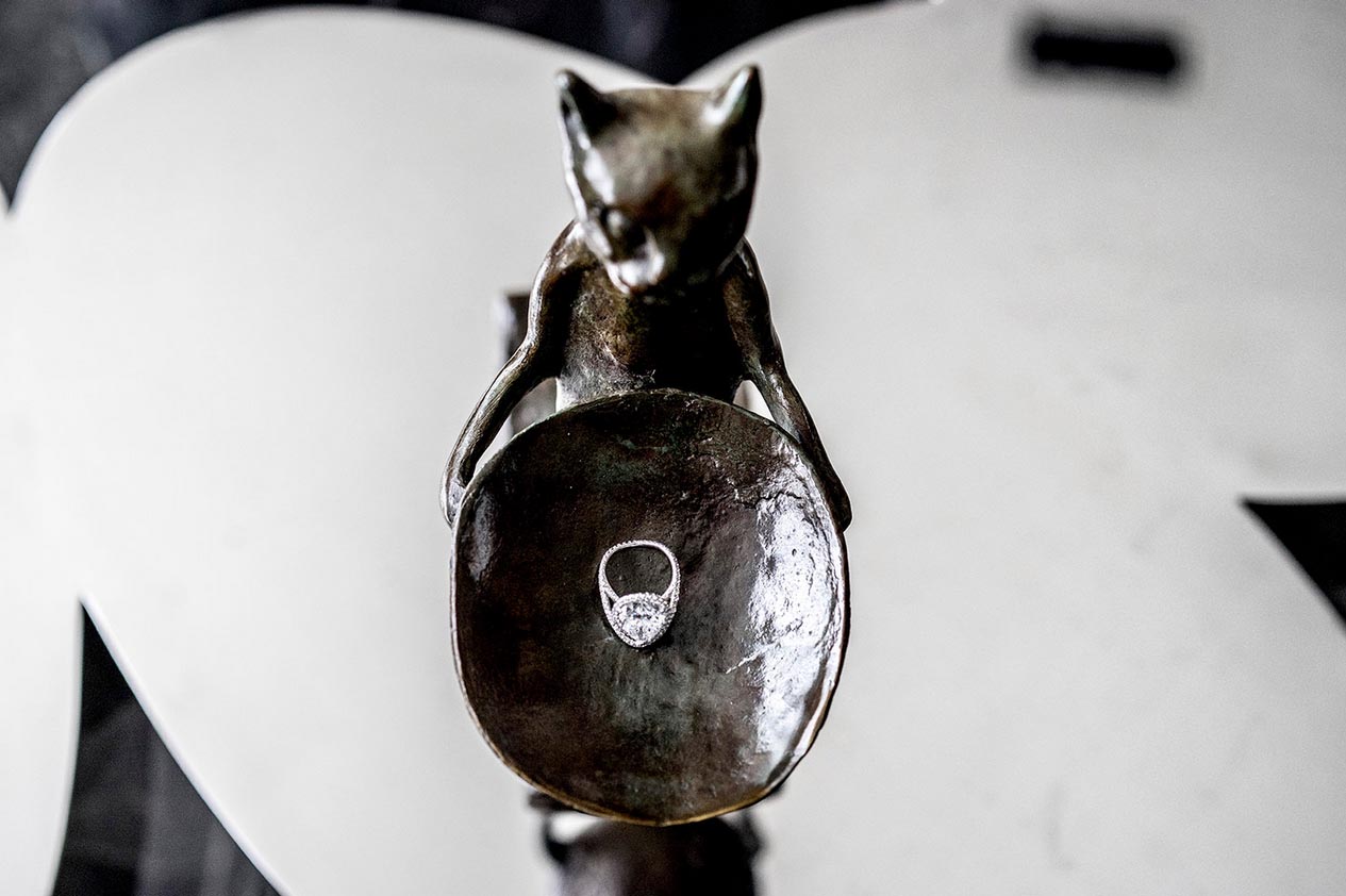 A bronze cat sculpture by Diego Giacometti holding the cushion-cut diamond that Ms. Syz put in a contemporary white-gold ring.